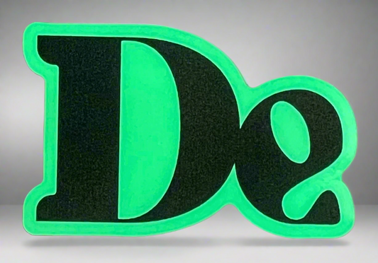 Glow-in-dark “De” stickers (two)