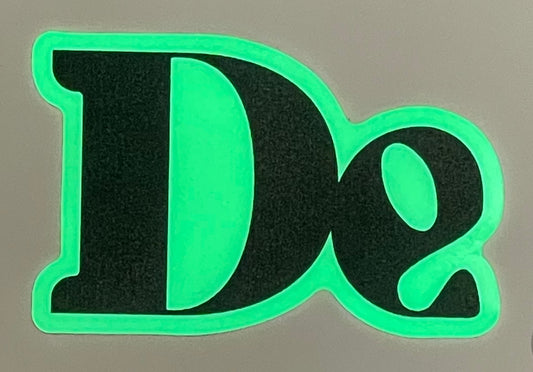 Glow-in-dark “De” stickers (two)