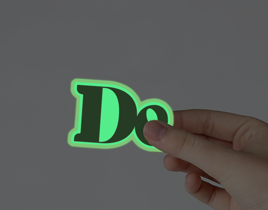 Glow-in-dark “De” stickers (two)